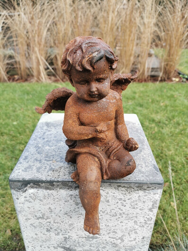 Antique garden sculpture of an Angel (boy) - Sitting model