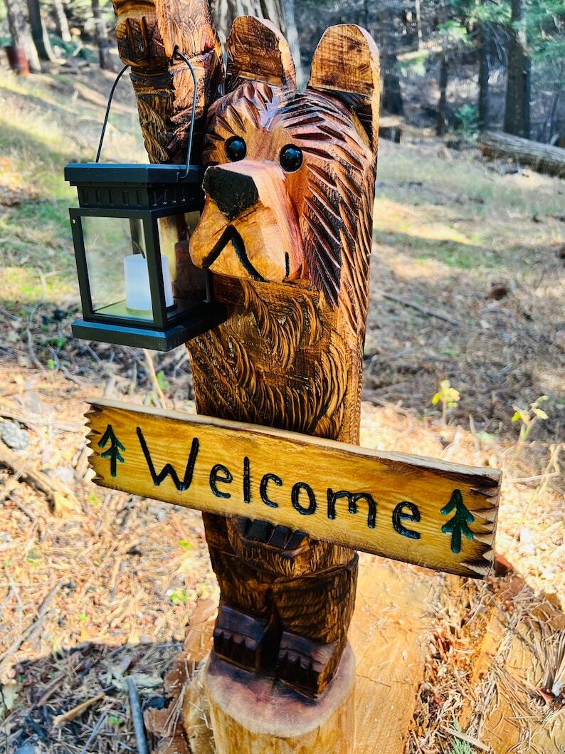 3ft cedar carved bear on stump with solar lantern and welcome sign