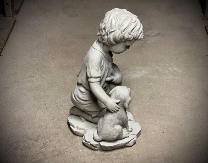 Realistic boy with dog statue Concrete boy with dog figurine Outdoor garden or backyard decoration