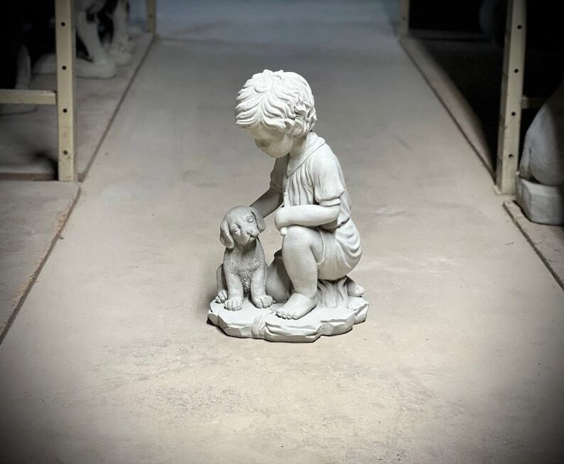 Realistic boy with dog statue Concrete boy with dog figurine Outdoor garden or backyard decoration